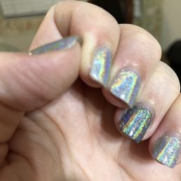 Hard to tell because of the metallic effect but chipped on edge of thumb and corner or pointer finger.