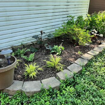 Amliv Land Designs - a flower bed in front of a house - Landscaping Near Me