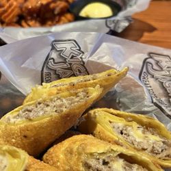 Kickback Jack's - Cheesesteak egg rolls with sweet potato fries in the background....