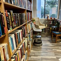 Jane & Evie's Used Books - Shelves of books and sitting area.
