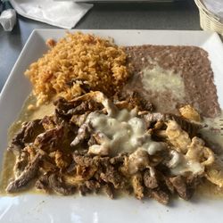 Mr. Pancho’s Mexican Restaurant - Mr. Bandido (chicken and steak smothered in queso with rice and refried beans)