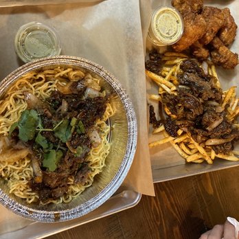 Nguyen's Kitchen - Left Side: Garlic Noodle w/Bulgogi Short Rib Steak  Right Side: Cajun Garlic Fries w/Bulgogi and Wings - Vietnamese Near Me - Costa Mesa, California