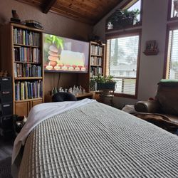 Roots of Healing Massage - A massage table set up in a living room ready for massage.