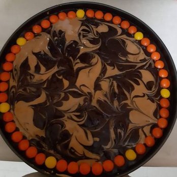 Baked Goods By Jess - a chocolate cake with orange and yellow sprinkles - Custom Cakes Near Me