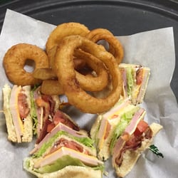 The Annex Bar & Grill - Club sandwich with onion rings.