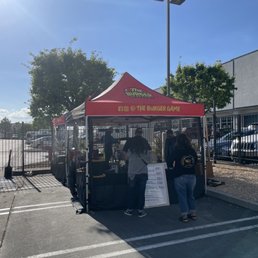 two people standing under a tent two people standing under a tent