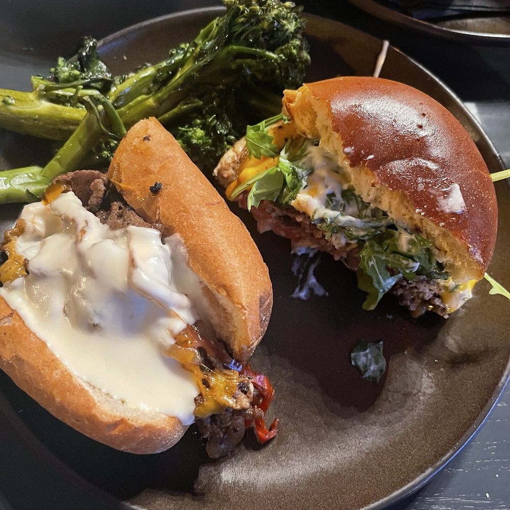 The Stubborn Mule - Half Chipotle cheesesteak/half smash burger with garlic broccolini - New American Near Me - Orlando, Florida The Stubborn Mule - Half Chipotle cheesesteak/half smash burger with garlic broccolini - New American Near Me - Orlando, Florida