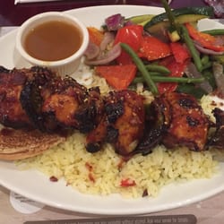 Rôtisserie Scores - Chicken brochettes with sides of roasted vegetables, served on rice.