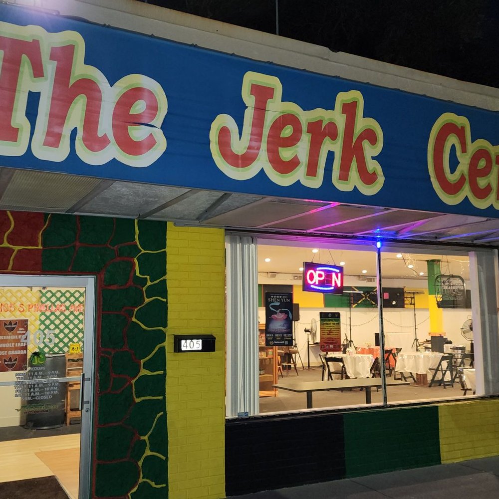 Jerk Center - Night time outside the restaurant. It's tucked away in the corner of the plaza next to a barber shop. - Caribbean Near Me - Tarpon Springs, Florida Jerk Center - Night time outside the restaurant. It's tucked away in the corner of the plaza next to a barber shop. - Caribbean Near Me - Tarpon Springs, Florida