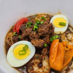 Loved Bayou - Yaka Mein Bowl- Fettuccine Noodles in a sweet savory Yaka Mein broth, topped with Braised Beef and Creole Shrimp, Boiled Egg and garnished a