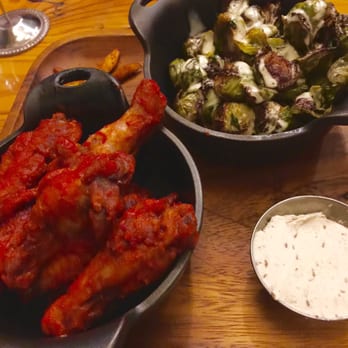First Draft Taproom & Kitchen - Harissa chili wings with creamy caraway cheese and crispy Brussels sprouts - Bars Near Me - Denver, Colorado