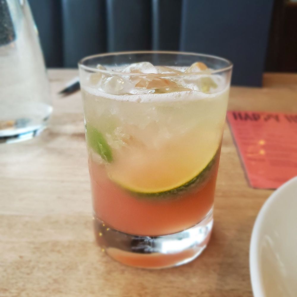 Earls Kitchen + Bar - Calamansi Caipirinha drink contains Calamansi, pomegranate, green tea and fresh lime juice - Canadian (New) Near Me - Vancouver, British Columbia