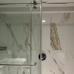 Large shower with powerful shower head. Cut shower time in half because pressure got soap and shampoo off fast.