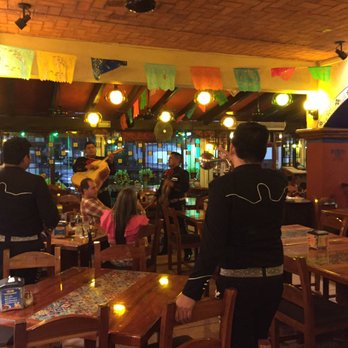 La Parrilla - Mariachi band playing for what appears to be a young couple. - Tacos Near Me - Cancún, ROO La Parrilla - Mariachi band playing for what appears to be a young couple. - Tacos Near Me - Cancún, ROO