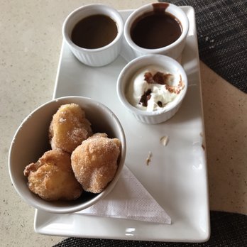 Kitchen76 - Beignets with salted Carmel and Hazelnut chocolate dipping sauces and real whipped cream. They are light as air! An unexpected delight! - Italian Near Me - Niagara-on-the-Lake, Ontario Kitchen76 - Beignets with salted Carmel and Hazelnut chocolate dipping sauces and real whipped cream. They are light as air! An unexpected delight! - Italian Near Me - Niagara-on-the-Lake, Ontario
