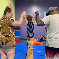 The Little Gym of Kalamazoo - Helping my son walk across the beam with Daddy