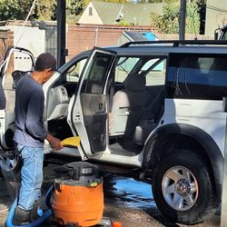 Modesto Hand Car Wash & Detail - This guy is coming behind the other guy to try to get the water out with a Shop-Vac it was not a successful job