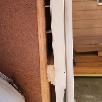 Tuff Shed Everett - The installers used wood chips, etc. to keep the door in. Notice the screws which are exposed because the frame was improperly construction. - Building Supplies Near Me - Everett, Washington