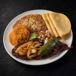 Fuego Cravings - A hearty 7oz steak served with fluffy rice, beans, creamy guacamole sauce, fresh pico de gallo, a chile toreado, and grilled onions.