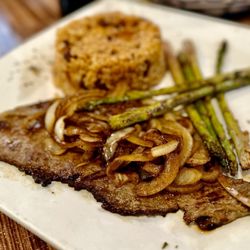 Punta Cana - Bistec Encebollado with Moro and Asparagus.