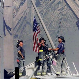 a group of firefighters holding a flag a group of firefighters holding a flag