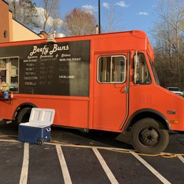 a man standing in front of a food truck