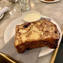 Fresh slice of bread pudding with vanilla sauce.