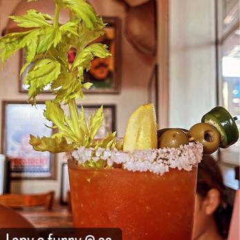 Lucy's Fried Chicken - a person holding a bloody drink - New American Near Me - Austin, Texas
