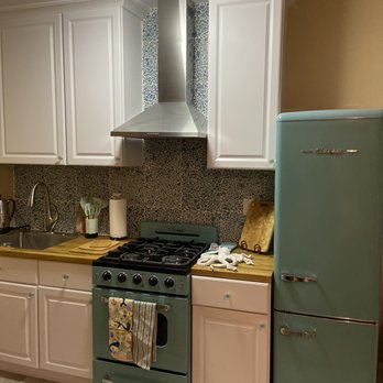 Gallery Renovation - a kitchen with white cabinets and green appliances - Handyman Near Me - Brooklyn, New York