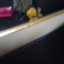 Comfort Suites - Mirror frame has damage.