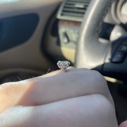 14k white gold solitaire oval moissanite engagement ring - gorgeous side detailing (reminds me of a lotus flower). I love it!