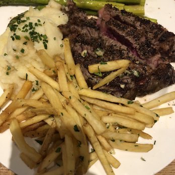 Earls Kitchen + Bar - Ribeye steak with sides of asparagus, mashed potatoes, and truffle fries which were a separate order (was feeling extra that day) - New American Near Me - McLean, Virginia