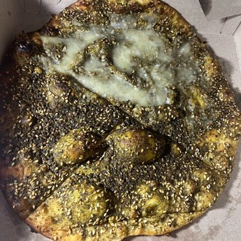 Cedar Mediterranean Restaurant - Za'atar Manakeesh (w/ added cheese on a quarter, quarter both, rest za'atar alone) - Lebanese Near Me - Rochester, New York