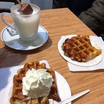 Salon de Chocolat - Hot chocolate (steamed milk with a big chunk of chocolate on a stir stick), one Belgian waffle with caramel and one with whipped cream. - Macarons Near Me - Gent, VOV Salon de Chocolat - Hot chocolate (steamed milk with a big chunk of chocolate on a stir stick), one Belgian waffle with caramel and one with whipped cream. - Macarons Near Me - Gent, VOV
