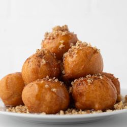 Pita Grill BK - Delicious Greek puffy like donuts with Honey topped with walnuts. Fresh and tasty.
