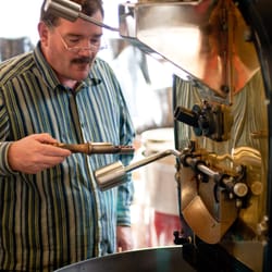 Carolines Coffee Roasters - Trace, our roaster, checking the state of the beans.