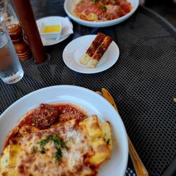 Mondo's Italian Restaurant - My baby-sized manicotti foreground, delicious focaccia bread melted butter, and the delicious spaghetti and meatballs!