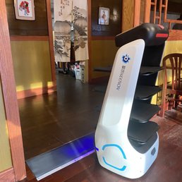 a robot sitting on the floor a robot sitting on the floor