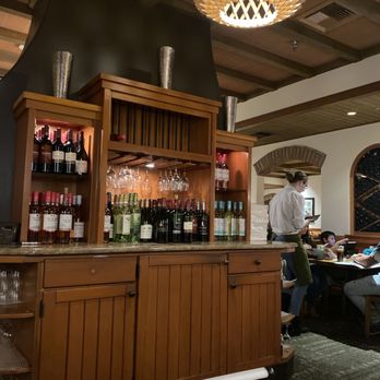 Olive Garden Italian Restaurant - a bar with wine bottles and wine glasses - Italian Near Me - Clermont, Florida