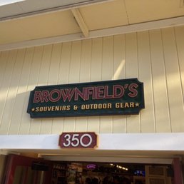 Exterior view of Brownfield's store, featuring a sign for souvenirs and outdoor gear, with the address 350 visible above the entrance.
