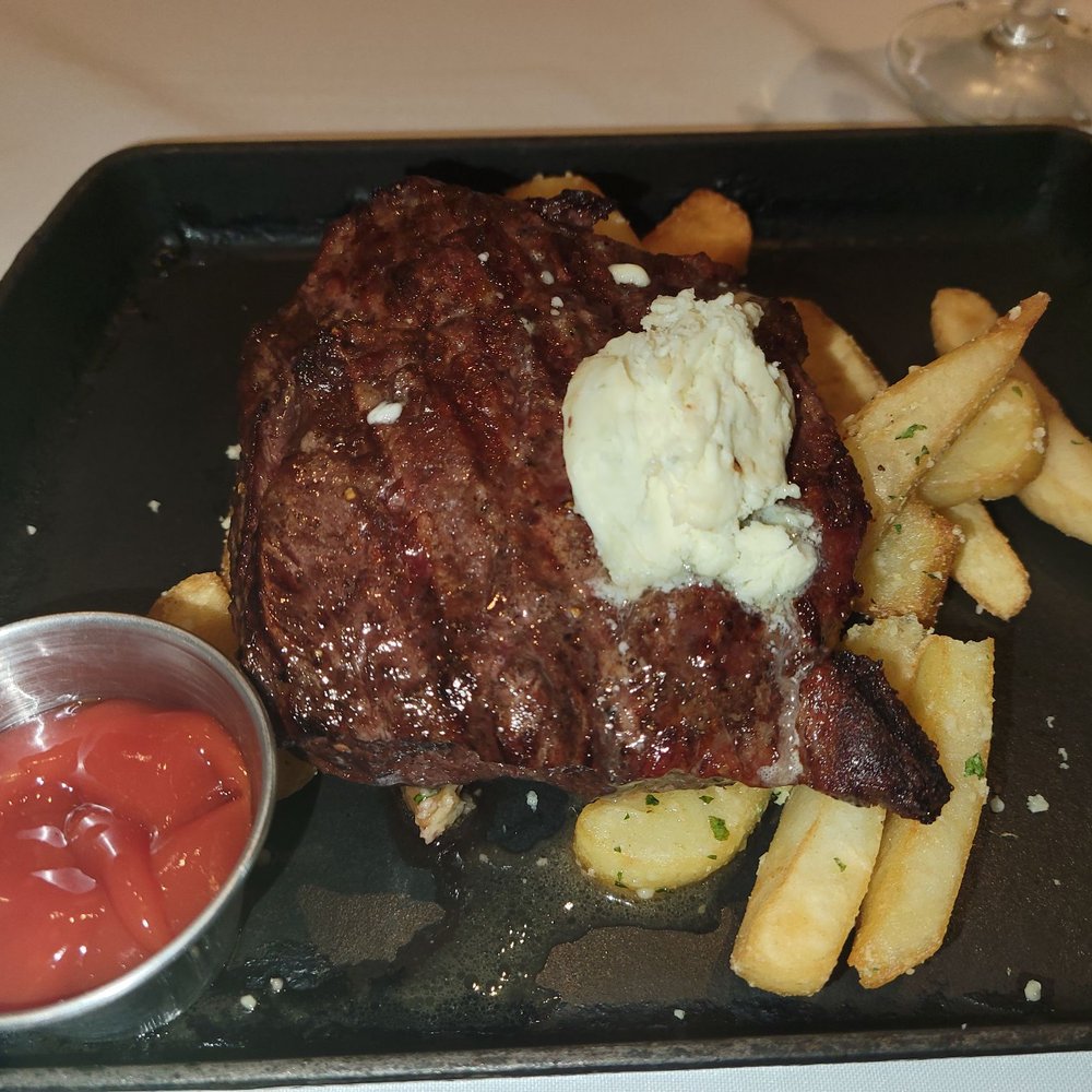 7593 Chophouse - Steak Frites herb marinated flat iron steak, truffle fries, blue cheese butter - Steakhouses Near Me - Reunion, Florida