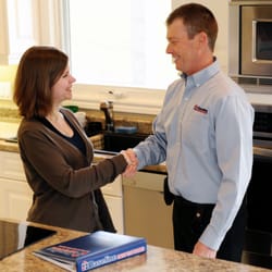 Baseline Inspections - Rod MacGillivray shaking hands with a client after a successful home inspection and discussion.