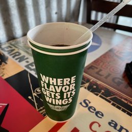 a cup of coffee with a straw in it