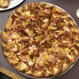 Pizza with Canadian bacon, bacon, barbecue chicken and pineapple Pizza with Canadian bacon, bacon, barbecue chicken and pineapple