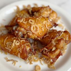 Manorah - Marinated fried chicken wings with crispy Thai basil, kaffir lime leaves and dried chili served with sweet chili sauce