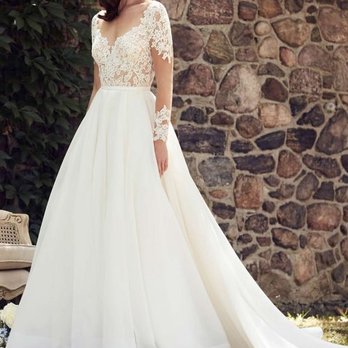 Veiled In Elegance - A stunning illusion Paloma Blanca gown with a soft, flowing organza skirt. - Bridal Near Me - Geneva, Illinois Veiled In Elegance - A stunning illusion Paloma Blanca gown with a soft, flowing organza skirt. - Bridal Near Me - Geneva, Illinois