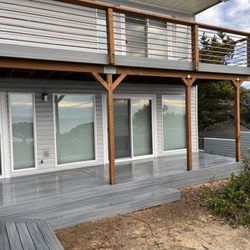 Coastal Breeze Construction - New deck with composite decking, custom copper pipe handrails