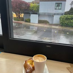a cup of coffee and a croissant