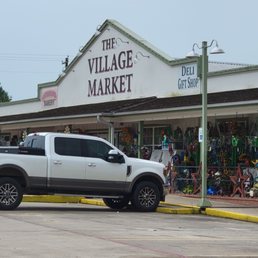 a pickup truck parked in front of the store