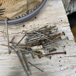 a pile of nails on a table a pile of nails on a table